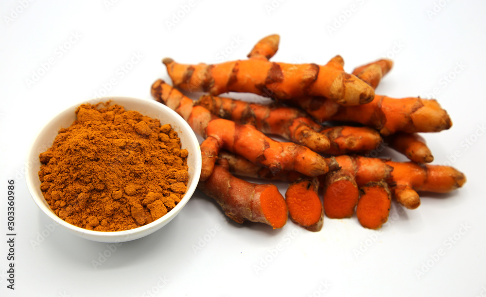 Composition with bowl of turmeric powder on white background. Composition with bowl of turmeric powder on white background.