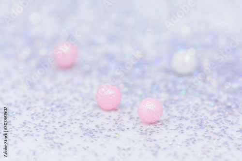 Delicate silver shiny background. Sugar balls and sparkles