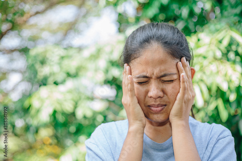 Young Woman Suffering From Painful Feeling headache , Healthcare Concept