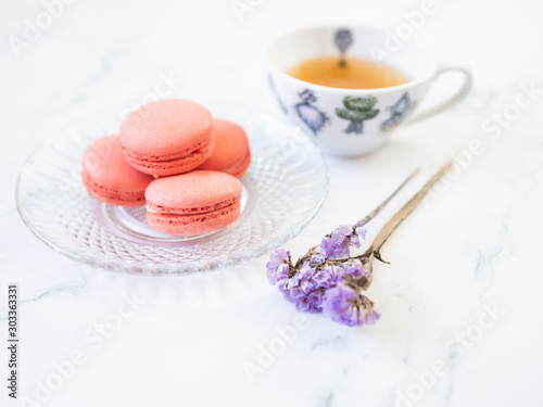 Closeup cup of hot tea set with macaroons and dried flowers Vintage style