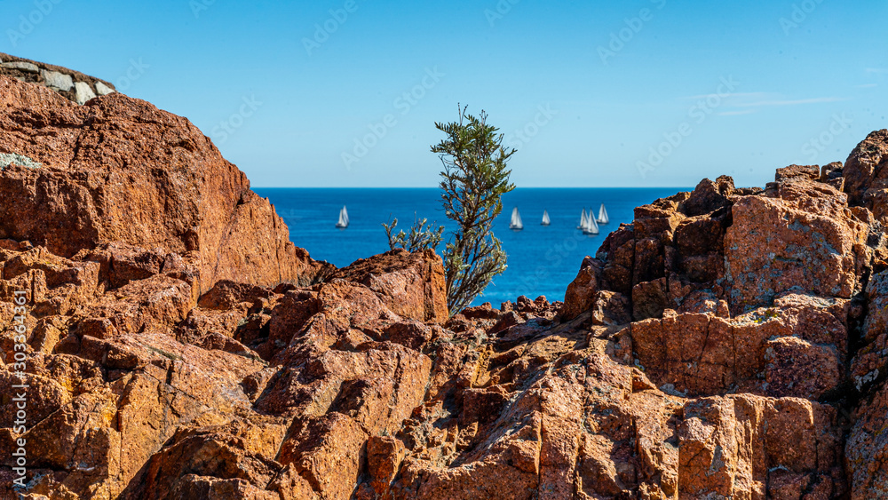 sailing boats view from cap roux hiking trail In the red rocks of the Esterel mountains with the blue sea of the Mediterranean