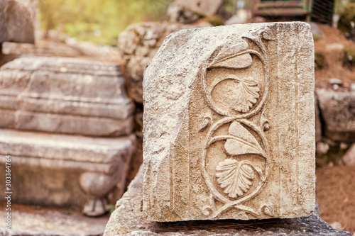 Ruins of ancient block with carved leafs and branches in it. Phaselis, Turkey.