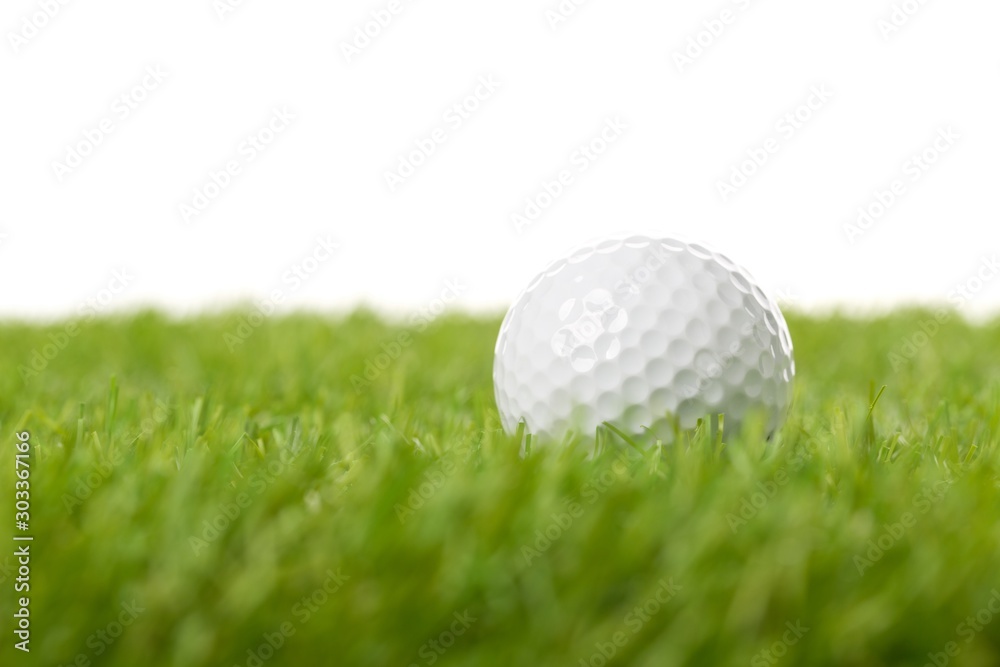 White golf ball on green grass lawn with copy space, isolated on white background White golf ball on green grass lawn with copy space, isolated on white background