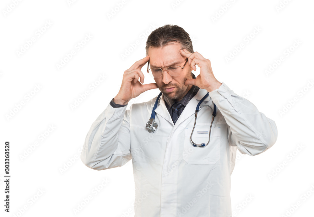 Middle age doctor man wearing coat and stethoscope standing isolated on white background suffering from headache desperate and stressed because pain and migraine. Middle age doctor man wearing coat and stethoscope standing isolated on white background suffering from headache desperate and stressed because pain and migraine.