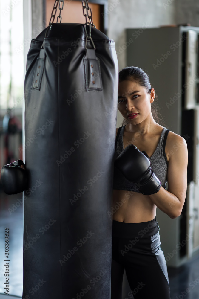 Beauty sexy woman hold punch bag in gym