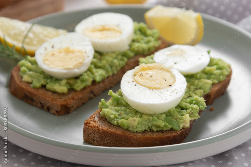 Avocado toast. Sandwich with egg, mashed on wholegrained bread. Healthy breakfast.