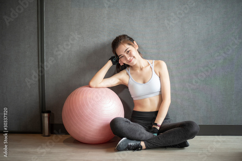 Beautiful asian woman is doing exercise in the gym photo