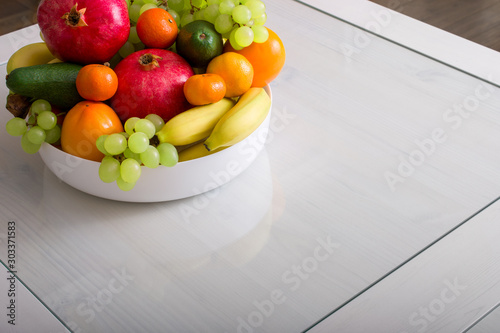 Fototapeta Naklejka Na Ścianę i Meble -  Delicious fresh fruits in plate on table, copy space.