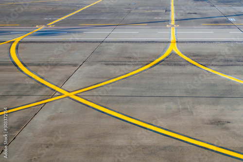 Airport runway, a part of road with yellow signal lines for aircraft, selective focus © Zarifa