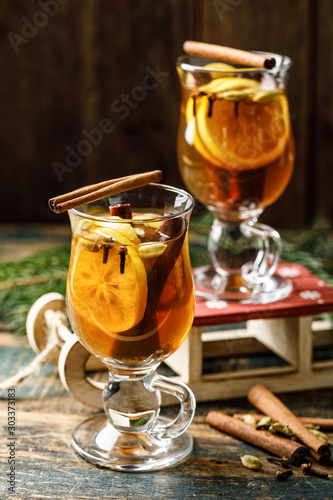 Grog. Hot drink for the winter holidays of the New Year and Christmas. Spicy tea and rum cocktail with lemon, cardamom, cinnamon and cloves.