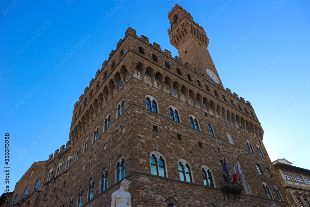Beautiful medieval Palazzo Vecchio in florence italy against a brightblue sky
