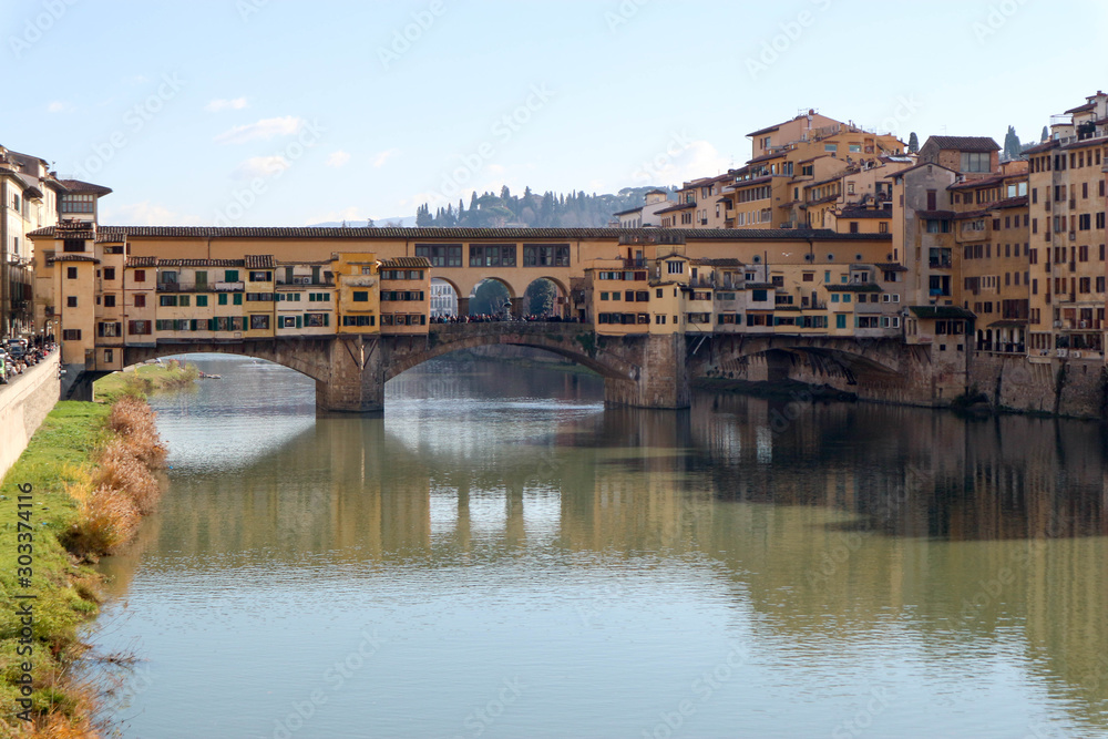 View to ponte vecchio in florence and its reflection in Arno river
