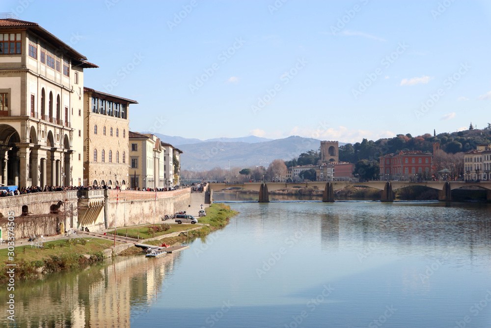 View to embankment of Arno river with bridge and medieval buildings, Florence, Italy