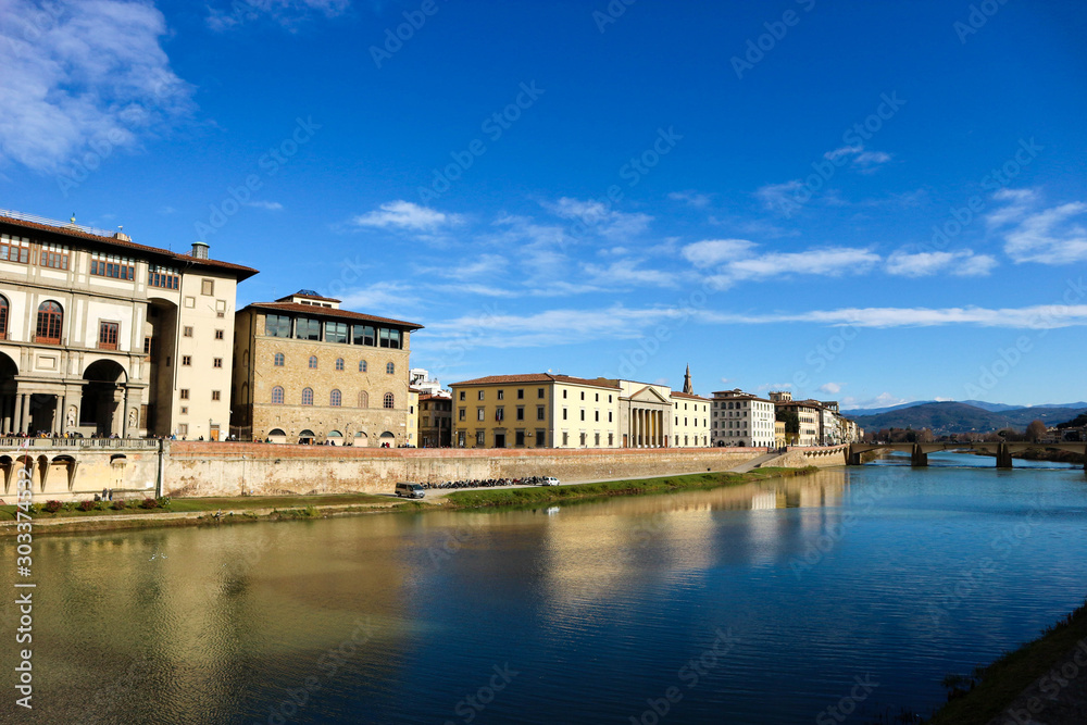 amazing view to arno river and medieval houses in florence under bright blue winter sky
