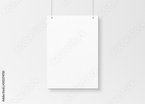 White poster isolated hanging by strings on wall mockup 3D rendering photo