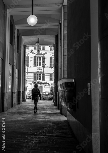 man walking along the streets of genua, italy