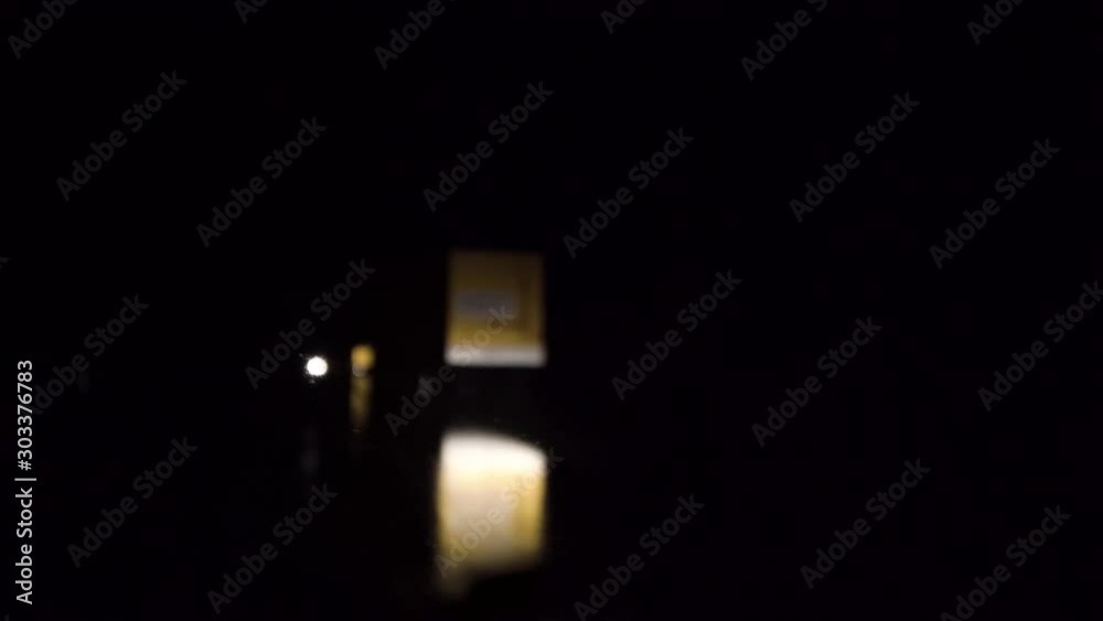 Abstract car headlights and street signs on a rainy weather. Night driving Abstract car headlights and street signs on a rainy weather. Night driving