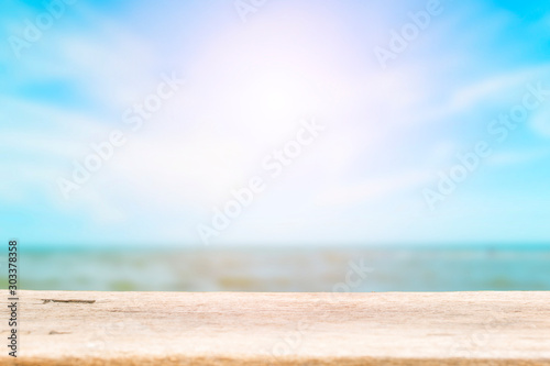 Wood table top on blur tropical sea background