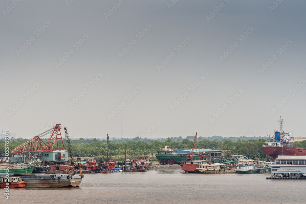 Grouping of idle boats and pontoons along Long Tau River, Ho Chi Minh City, Vietnam.