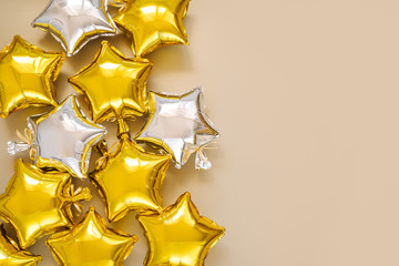Gold and silver foil balloons of star shaped. Holiday and celebration concept. Birthday Day or party decoration. Metallic air balloons. Congratulation. Greeting card.
