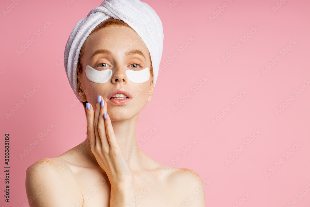 Young woman with patches under eyes isolated on pink background Young woman with patches under eyes isolated on pink background