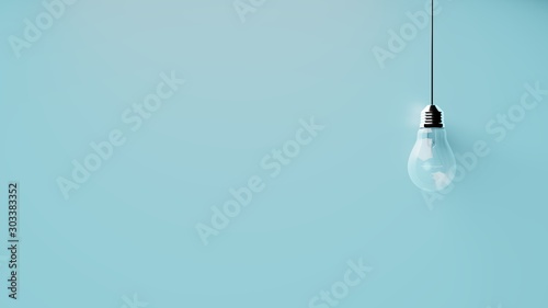 Singular hanging light bulb on bright blue background with space for text