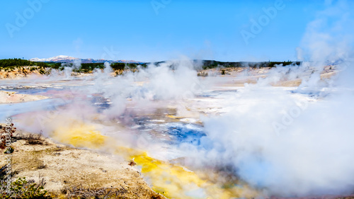 Colloidal Pool and other Geysers under blue sky in the Porcelain Basin of Norris Geyser Basin area in Yellowstone National Park in Wyoming, United States of America