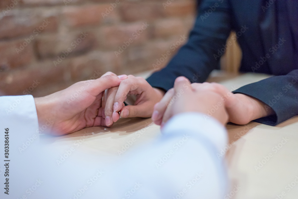 Young couple joining hands in cafe place. Man and woman holding hands. Lovers, family, trust, love and happiness concept. Enjoying date in coffee house concept. 