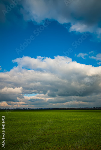 Sky and clouds and green field in the countryside, landscape.