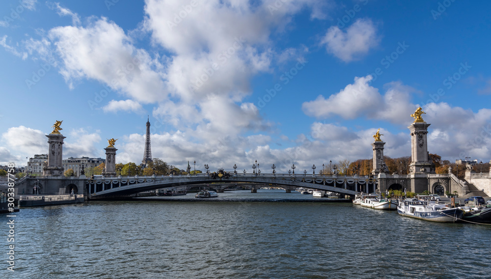 Pont Alexandre III seen from the boat. In distance there is of Eiffel tower showing up. The most extravagant bridge of Paris