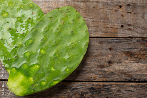 Mexican fresh nopal cactus ingredient on wooden background