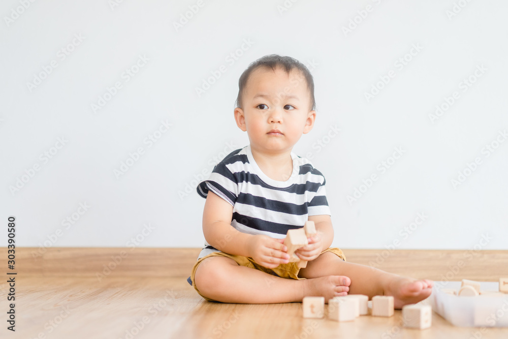 2 years baby boy.Little child boy playing with lots of wooden toys block with mother.Kids play with educational toys at home.Day care and Kindergarten school.child development concept. 2 years baby boy.Little child boy playing with lots of wooden toys block with mother.Kids play with educational toys at home.Day care and Kindergarten school.child development concept.