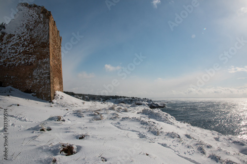 Uluzzo tower after a exceptional snowfall, Salento, Italy