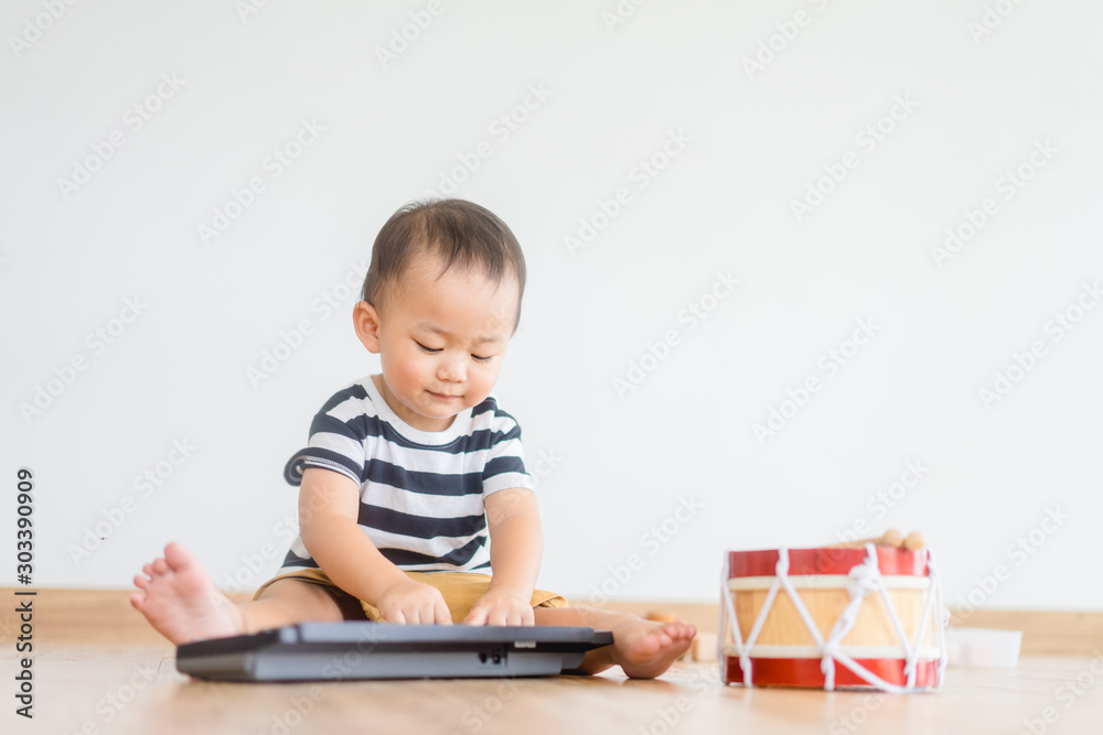 Little baby boy play keyboard and drum at home.Asian boy playing and singing happy moment in music time. Little baby boy play keyboard and drum at home.Asian boy playing and singing happy moment in music time.