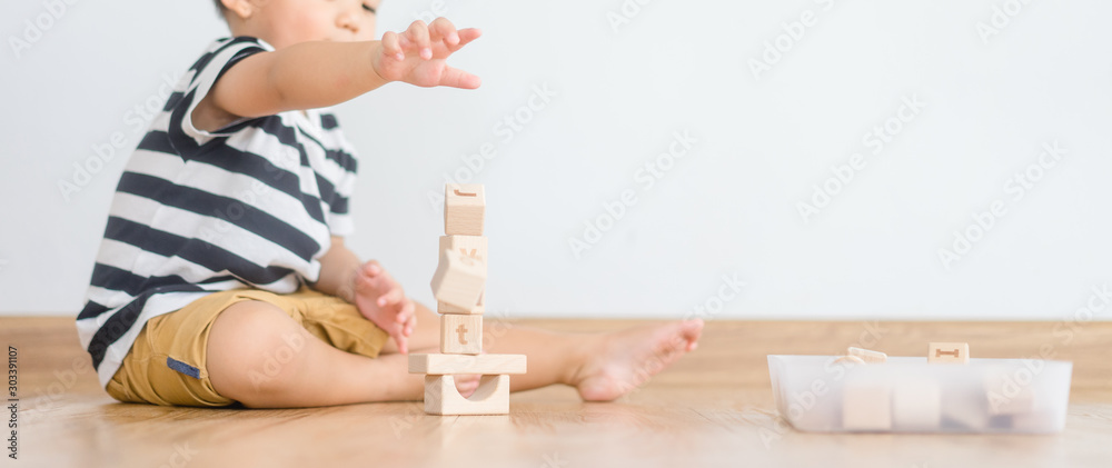 2 years baby boy.Little child boy playing with lots of wooden toys block with mother.Kids play with educational toys at home.Day care and Kindergarten school.child development concept. - obrazy, fototapety, plakaty 
