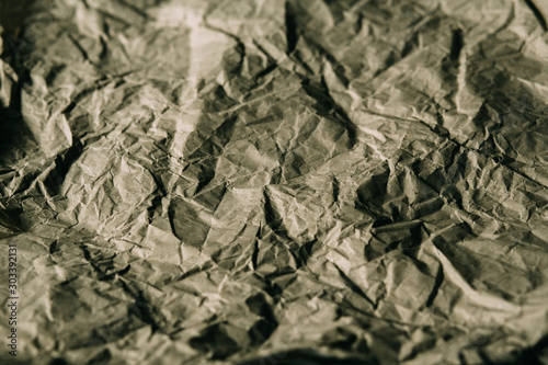 Texture of crumpled brown paper. Rough paper background for design. Abstract texture and background made with wrinkled paper.