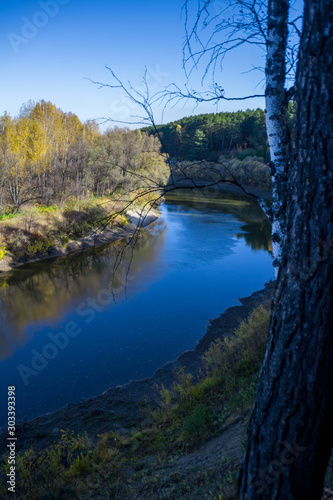 Fototapeta Naklejka Na Ścianę i Meble -  Beautiful river among the forest and ravines. Among the birches and pines.