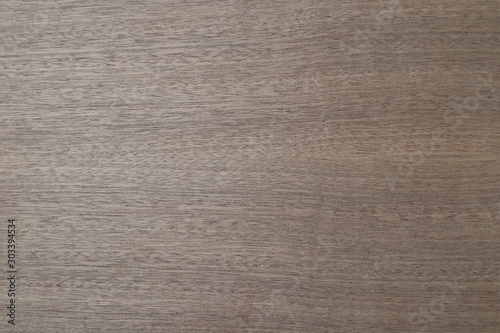 Light brown wooden laminate background. Flooring: smooth wood, walnut, ash, beech. Veneer coating.