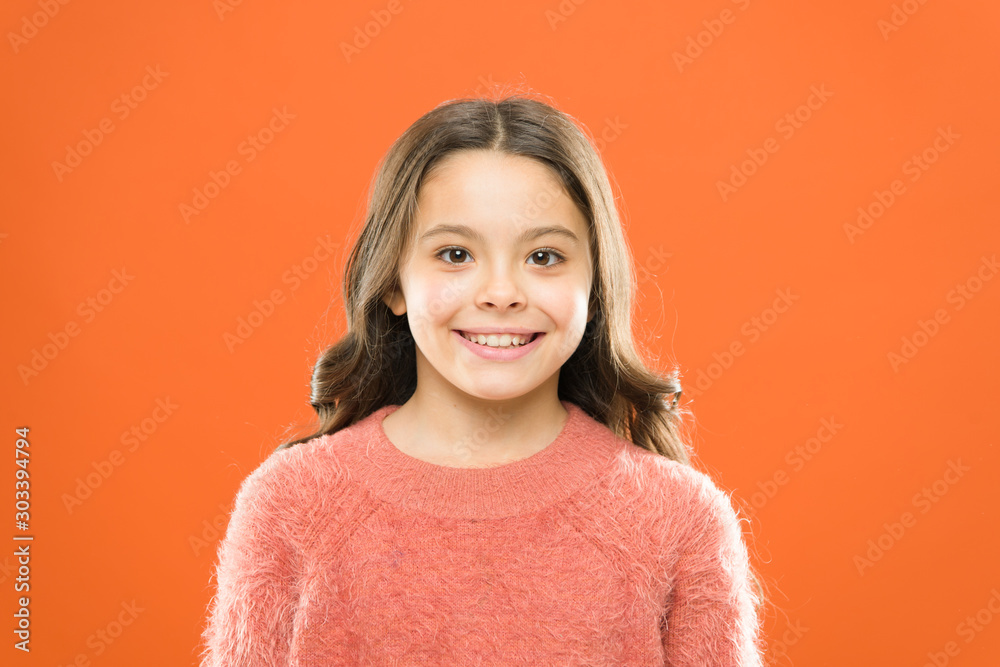 cute little girl smiling. small kid autumn sweater. feel comfortable in casual fashion. cheerful child orange background. carefree childhood. her healthy smile. happy childrens day. be in a good mood cute little girl smiling. small kid autumn sweater. feel comfortable in casual fashion. cheerful child orange background. carefree childhood. her healthy smile. happy childrens day. be in a good mood