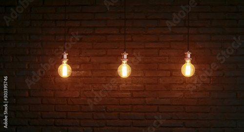 Three Edison lamps against a structured brick wall.
