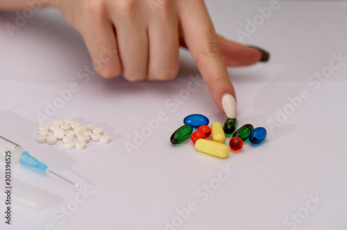 Girl addict with pills and capsules. Drug addict training. Social problems