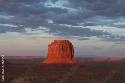 Sunset light above a rock formation in the middle of a desert area, Monument Valley, USA