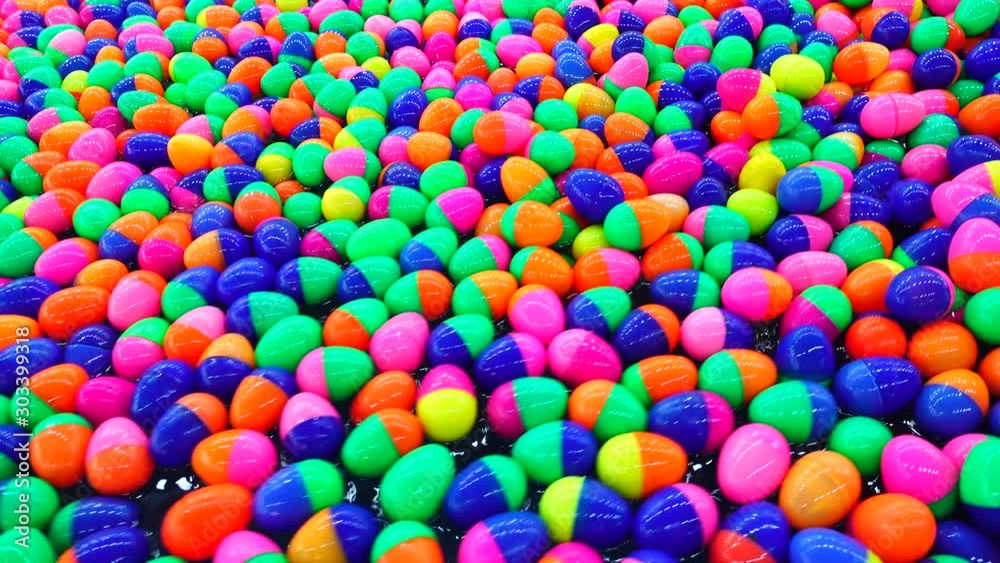 4K Red green orange ping blue plastic ball in the playground water 4K Red green orange ping blue plastic ball in the playground water