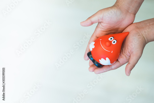 Female hands holding and give red blood for transfusion Blood donor at donation with a bouncy ball holding in hand.Concept image for World blood donor day, healthcare, medicine and blood donation.