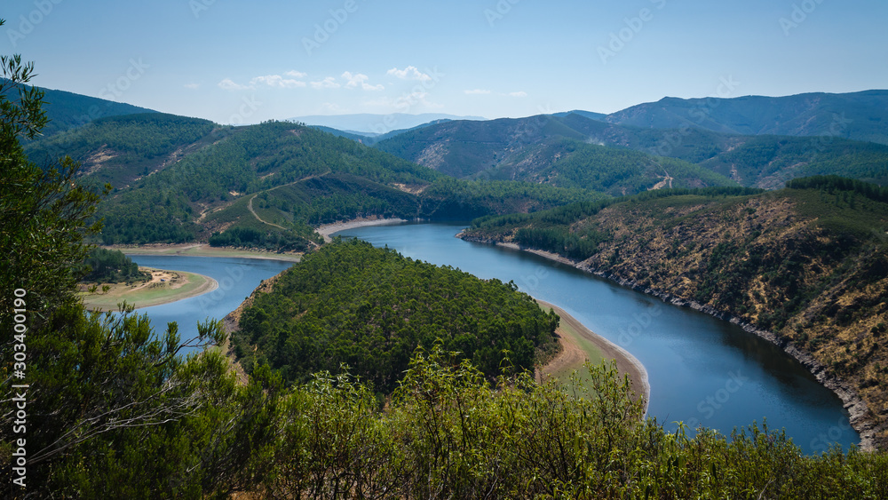 Meander of Melero with mountains around and a blue sky, Riomalo de Abajo (Cáceres), Spain