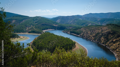 Meander of Melero with mountains around and a blue sky, Riomalo de Abajo (Cáceres), Spain