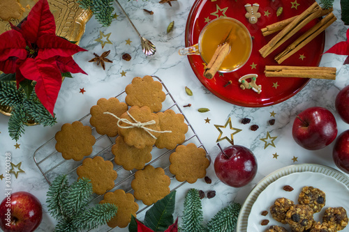 Food photography of a Christmas table decorated with gingersnap cookies, cinnamon and pine photo