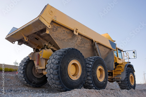 Heavy Construction Equipment Dump Truck against a blue sky photo