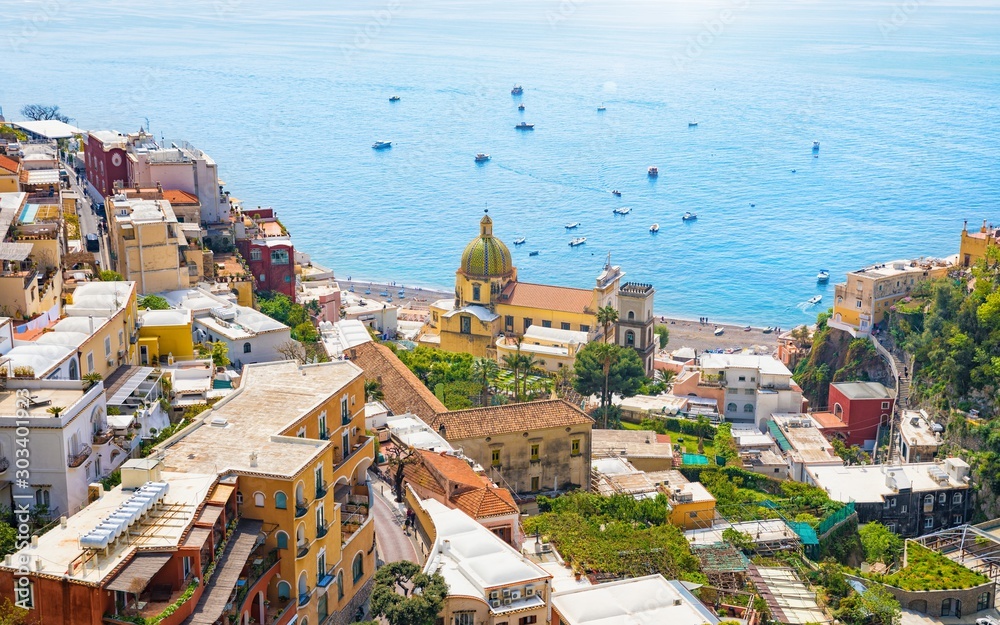Beautiful Positano on hills leading down to coast and azure sea on Amalfi Coast in Campania, Italy. Amalfi coast is most popular travel and holiday destination in Europe.