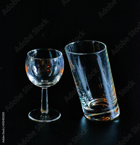 Glass and inclined glass on a black background